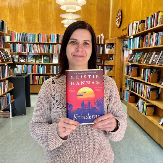 Bibliotekar Marianne med bogen "Kvinder" af Kristin Hannah.